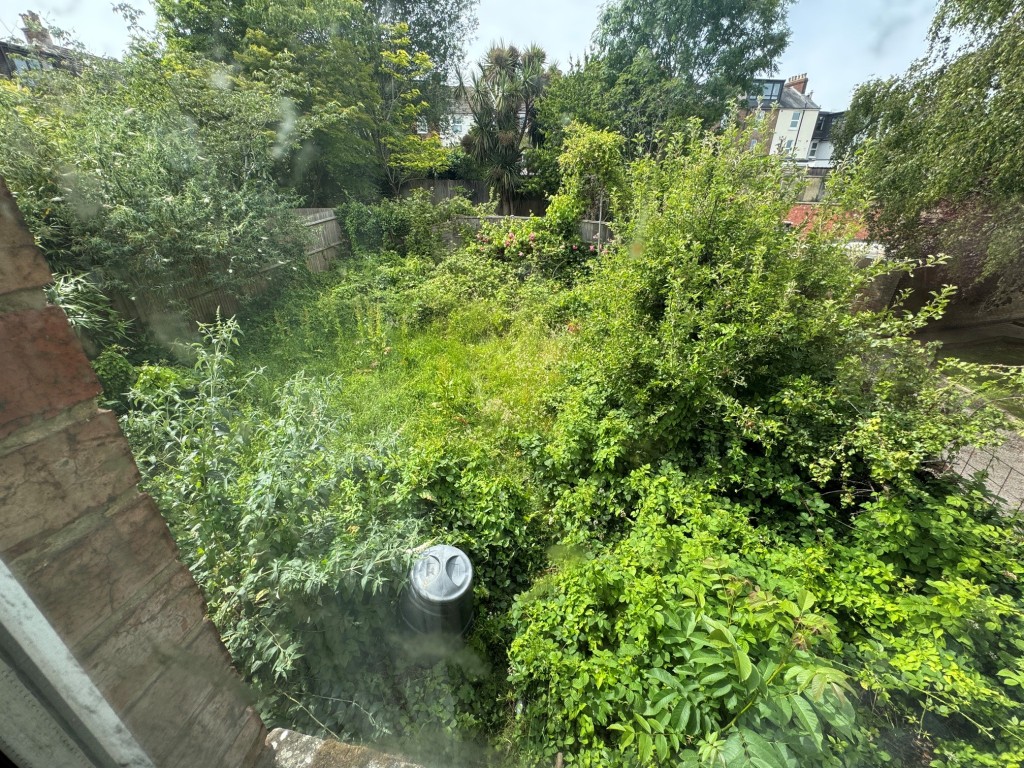 Lot: 101 - DETACHED FOUR-BEDROOM HOUSE FOR IMPROVEMENT - Rear garden taken from first floor window